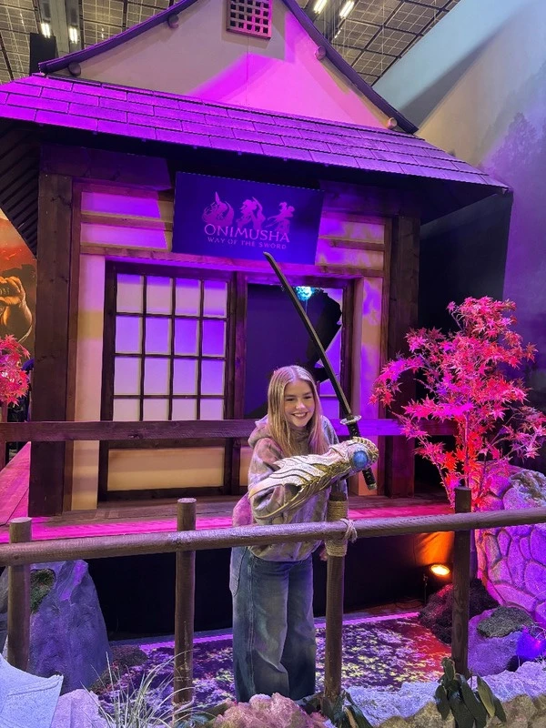 Visitor holding a prop sword in Capcom's Onimusha environment at Paris Games Week