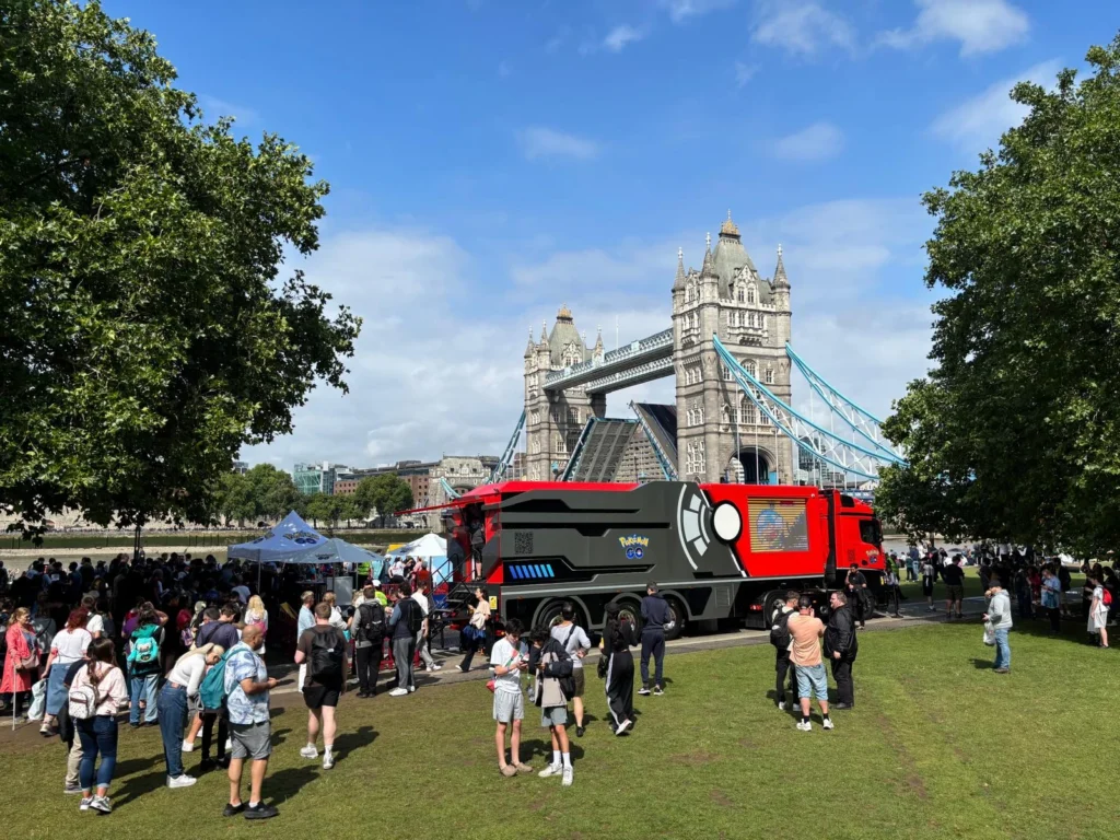 Pokémon GO roadshow truck and visitors beside Tower Bridge in London