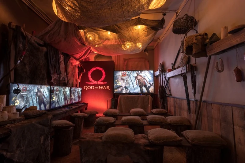 God of War hospitality room with game stations and Viking-inspired scenery