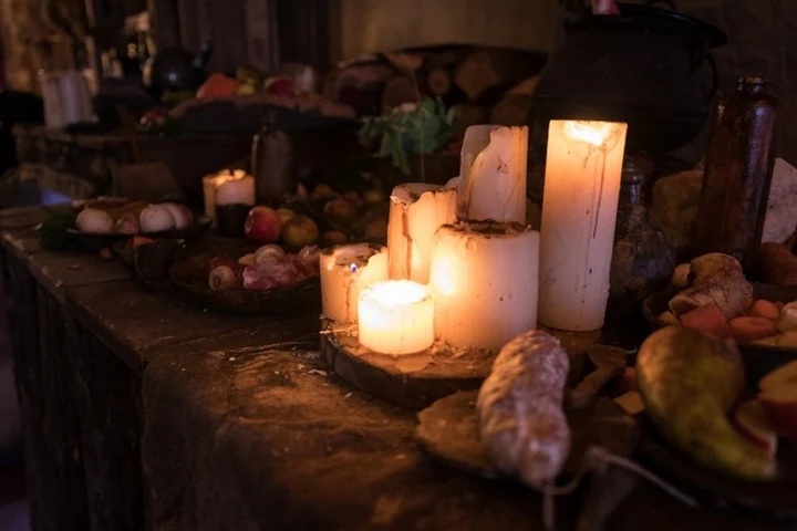 Candlelit hospitality table inside the God of War venue