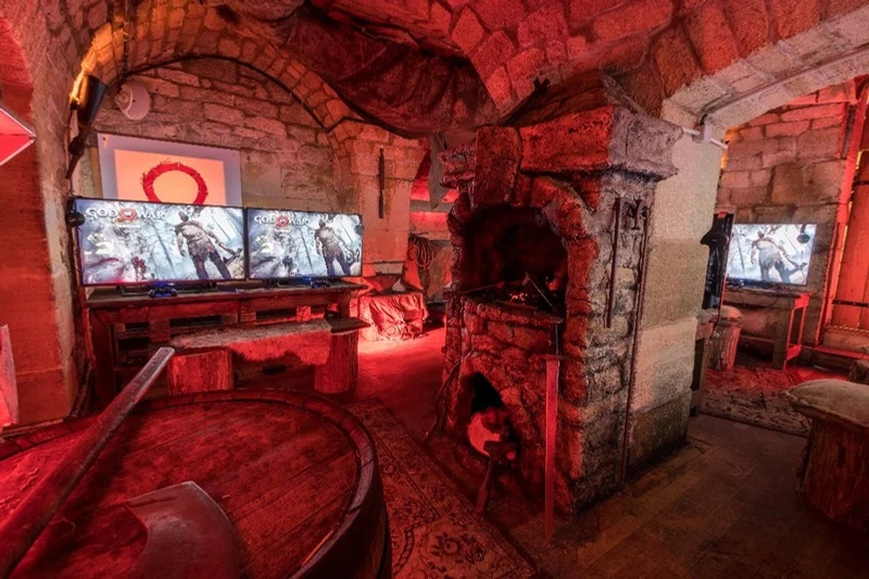 Game-testing stations in a vaulted room lit in red