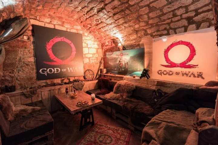 God of War guest area with seating and game screens
