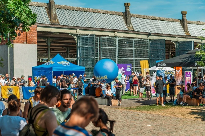Visitors around Pokemon GO tents at a community event