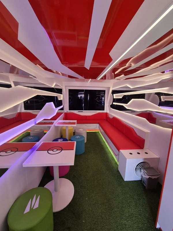 Interior of the Pokemon GO truck with seating and game-inspired scenery